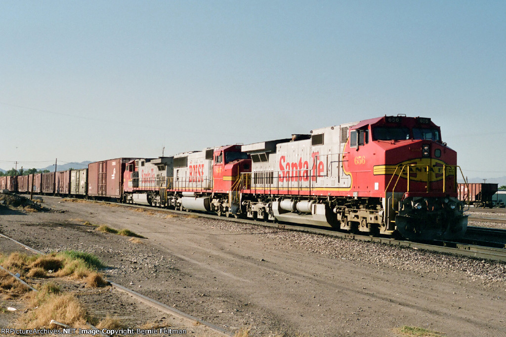 Santa Fe C44-9W's 656 & 661 bracket BNSF SD75M as they lead an eastbound past the depot
